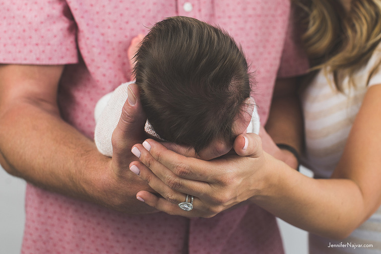 Newborn baby in new parents hands