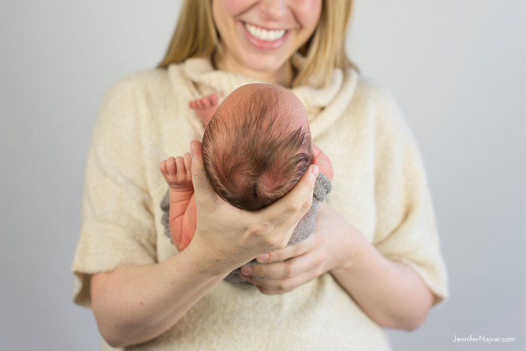 newborn in moms arms studio portrait