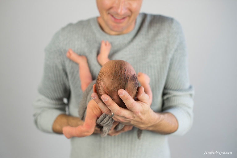 newborn baby in dad's hands