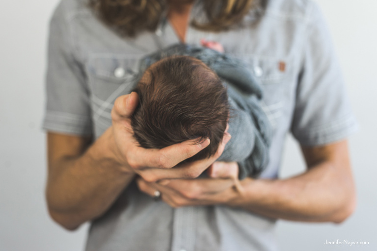 newborn baby in fathers hands